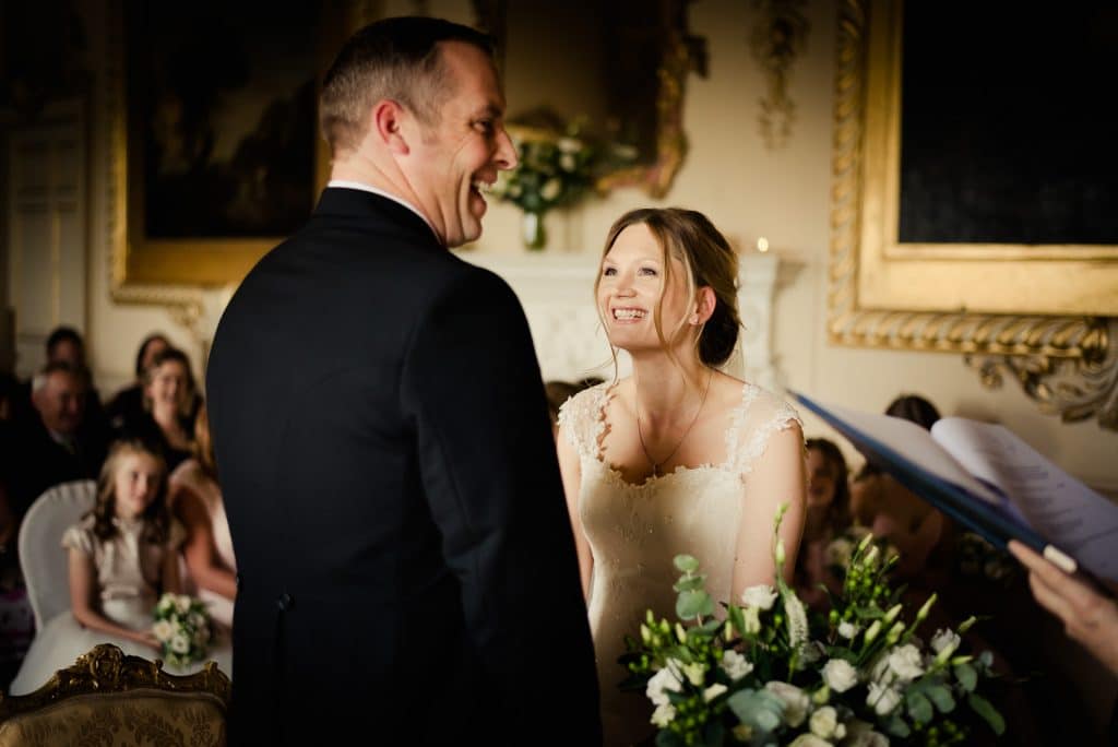 Laughing couple exchanging vows in Carton House
