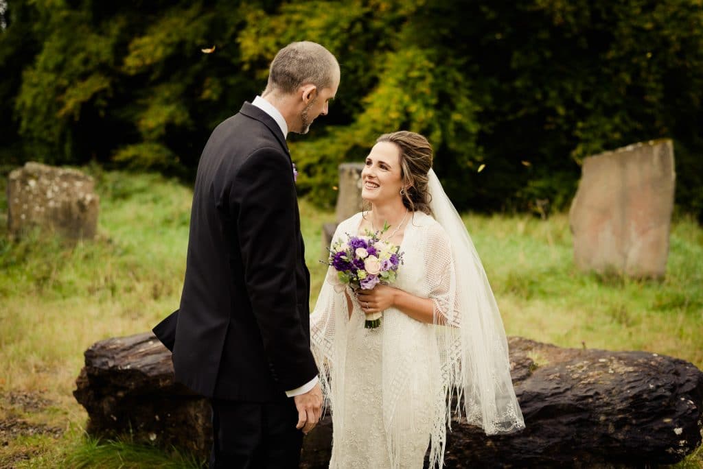 Smiling eloping couple exchange vows at Kinnitty Castle stone ciircle