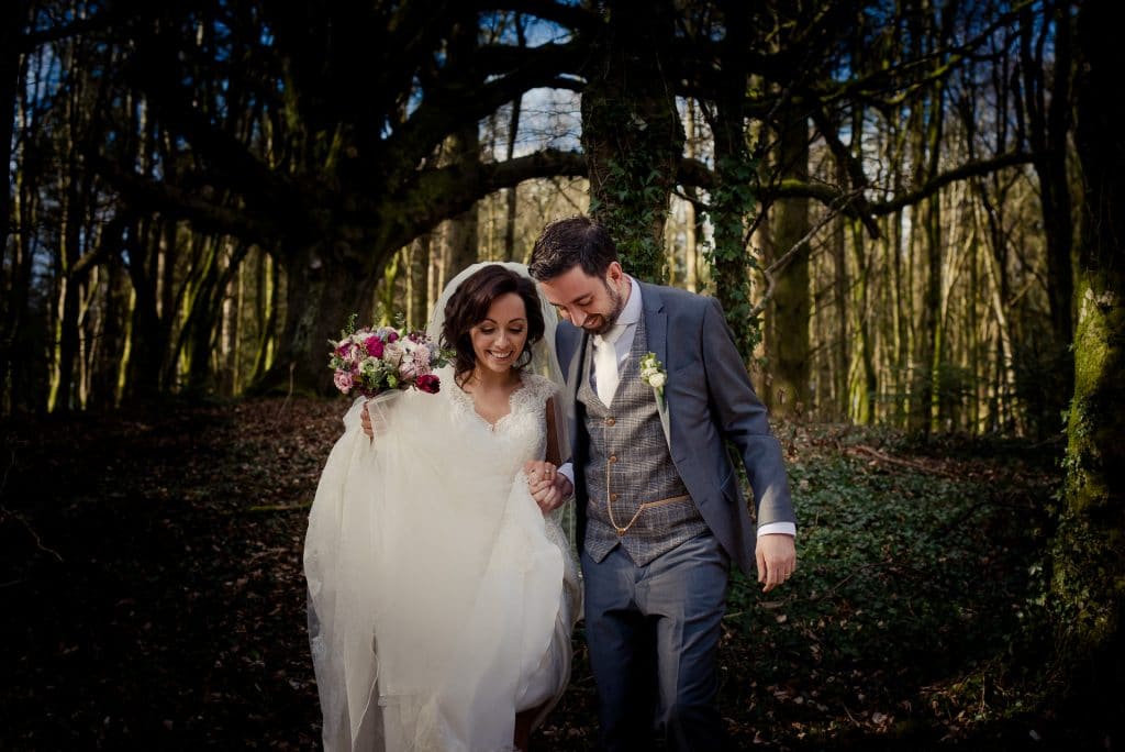 Wedding couple walking in Kinnitty Castle woods