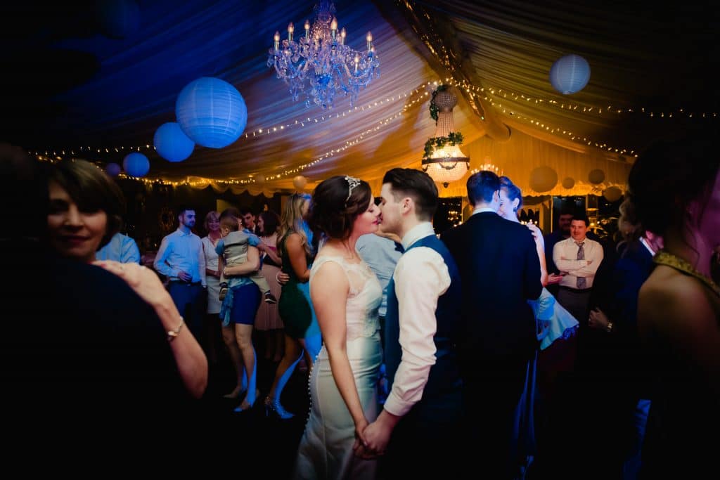 Wedding couple kissing on dance floor in Tinakilly House
